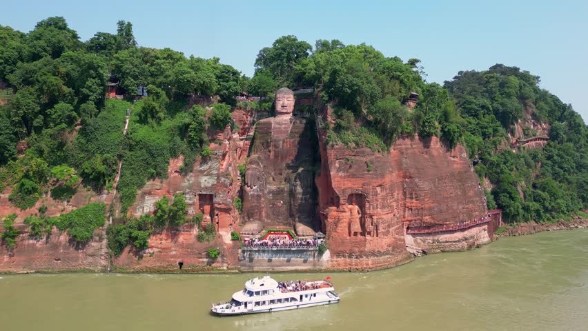 Leshan, China: Aerial drone footage of the famous Leshan giant Buddha stone statue  at the confluence of the Min River and Dadu River in Sichuan in China. Shot with an orbit motion