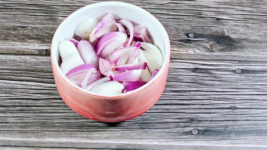 slices of red onion with vinegar, Red onions, purple or blue onions, often consumed raw, cultivars of the onion (Allium cepa), and have purplish-red skin and white flesh tinged with red
