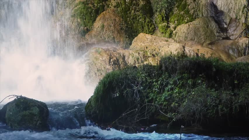 Majestic Waterfall Cascading Rocks Lush Greenery Nature Scene Water Flowing Powerful Spray Mist Tranquil Beauty Serene Environment Wild Landscape