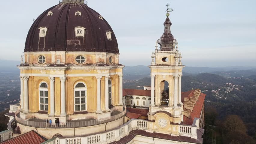Aerial perspective showcases the Basilica of Superga nestled amidst autumnal foliage in Turin, Italy