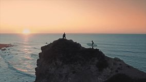 Sunset Coastal Clifftop Adventure Three Hikers Ocean View Surfboards Backpacks Golden Hour Dramatic Landscape Photography - Powered by Shutterstock - Get 15% off with code: PIKWIZARD15