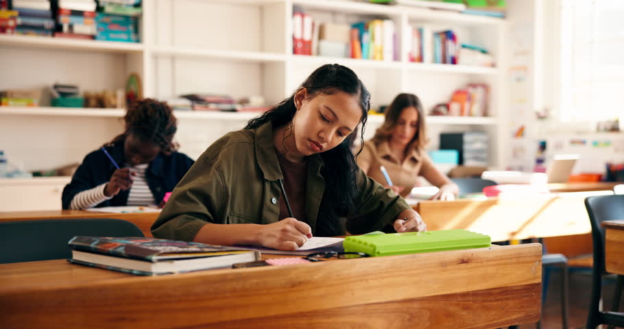 High school, learning and students in classroom listening for lecture, test and lesson. Campus, academy and teenagers with notes, books and writing for education, knowledge or studying for assessment