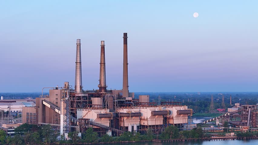 DTE River Rouge Power Plant with moon above during early evening in Michigan, USA