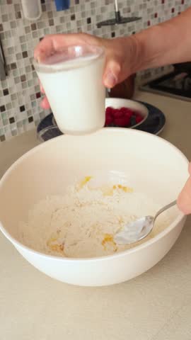 Anonymous add milk to pancake batter. Calories, breakfast and cooking at home in the kitchen.