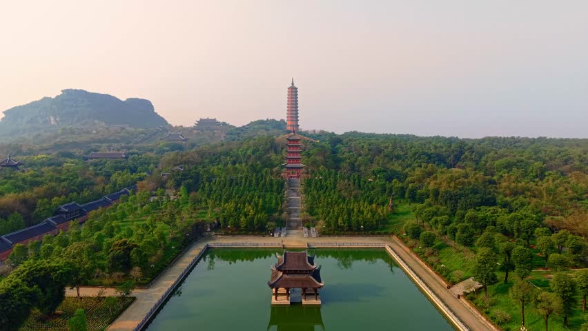 Aerial view of bai dinh pagoda in lush Ninh Binh landscape under blue sky.