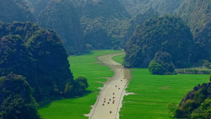 Scenic boat tour in Ninh Binh Tam coc lush landscape and limestone caves.