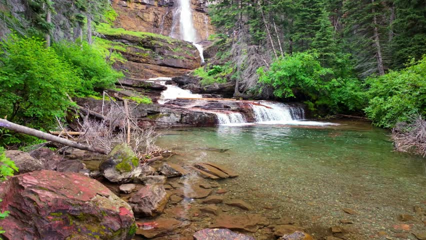 A close-up view captures the scenic Virginia Waterfall on a summer day in Glacier National Park