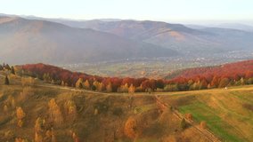 Stunning bird's eye view of a valley spread out among autumn hills in the golden light of dusk. Cinematic footage. Yaremche town, Carpathian, Ukraine. Filmed in UHD 4k. Discovery the beauty of earth. - Powered by Shutterstock - Get 15% off with code: PIKWIZARD15