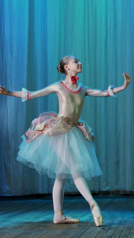 Ballet rehearsal, on the stage of the old theater hall. Young ballerinas in elegant dresses and pointe shoes, dance elegantly certain ballet motions, pass, scenic bow.