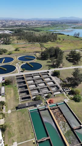 Drone aerial video water sanitation plant in 4K. Footage shows decanters, tanks, and treatment facilities operating within industrial infrastructure. Ideal for educational projects.