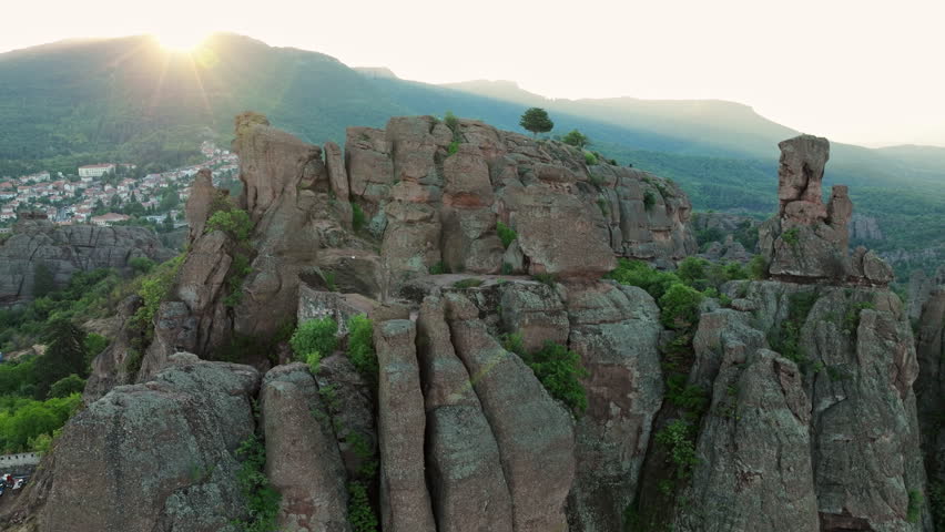 Aerial panoramic Belogradchik Rocks Bulgaria cliffs fortress, Balkan mountains horizon, cultural site, natural attraction, famous landmark, green vegetation, geological wonder, travel inspiration
