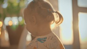 In a sunny room, a girl plays with iridescent bubbles with delight. A warm atmosphere fills the room, and the game turns into a fun pastime for the child - Powered by Shutterstock - Get 15% off with code: PIKWIZARD15