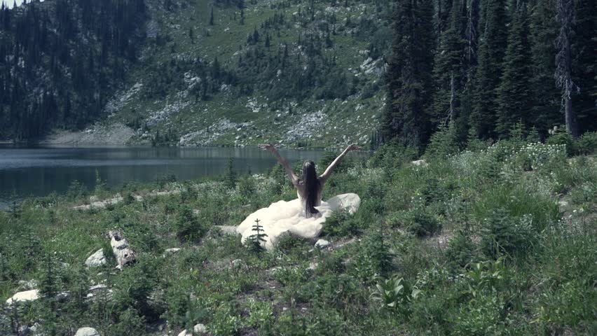 Slow motion water woman white dress in the Mountains Beautiful lake spiritual