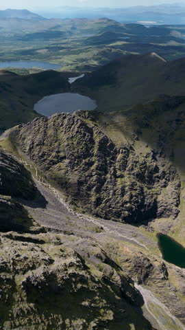 Drone footage of Carrauntoohil, Ireland’s highest peak, with sweeping views of rugged mountains, valleys, and dramatic landscapes in County Kerry