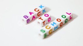 Back to school spelled out on white beads on white background. - Powered by Shutterstock - Get 15% off with code: PIKWIZARD15
