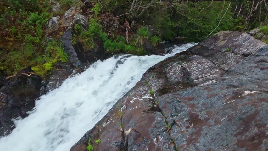 A scenic view captures the beauty of Grotto Falls within the Custer Gallatin National Forest on summer day