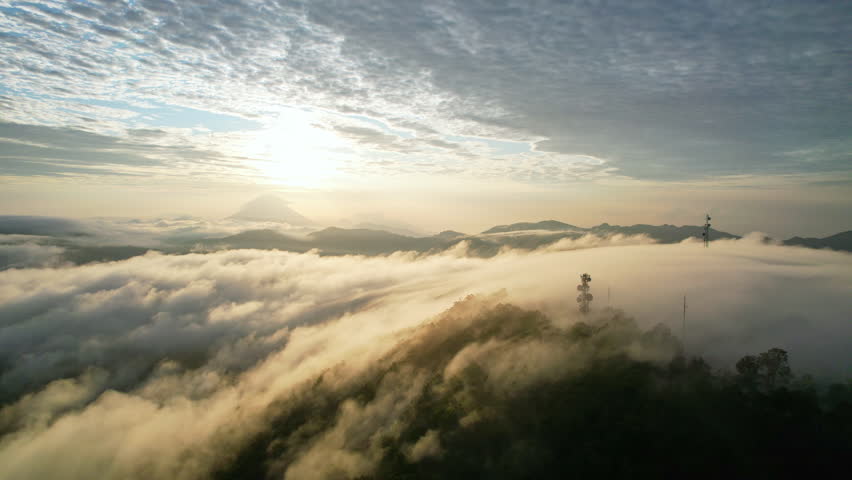 Aerial drone footage of a sea of clouds during sunrise in Bajawa area, Flores island, Indonesia