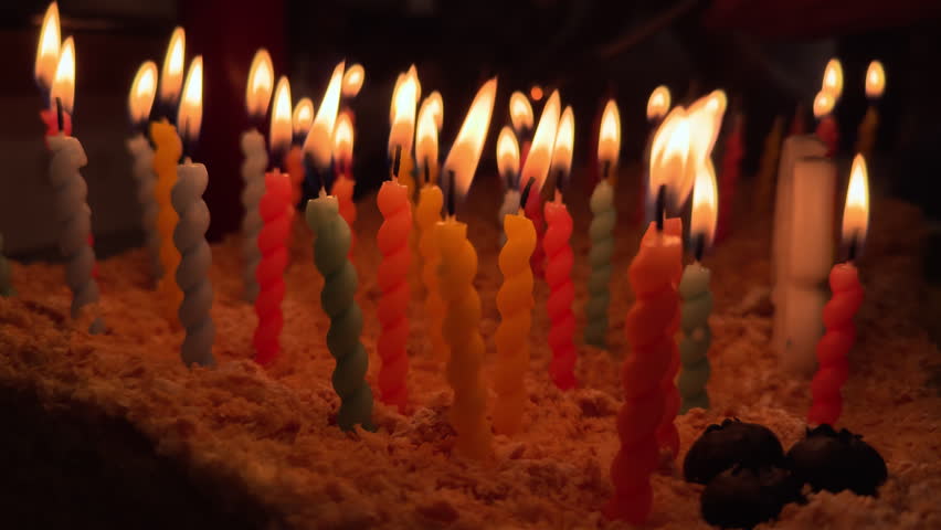 Close up shot of candles on the birthday cake. Happy Birthday friendship, holidays, celebration, present
