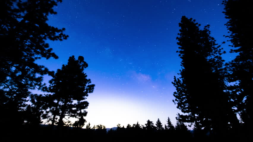 Milky Way Galaxy Sunset in Southeast Sky Over Pine Trees 15mm Tilt Up Astrophotography Time Lapse California USA