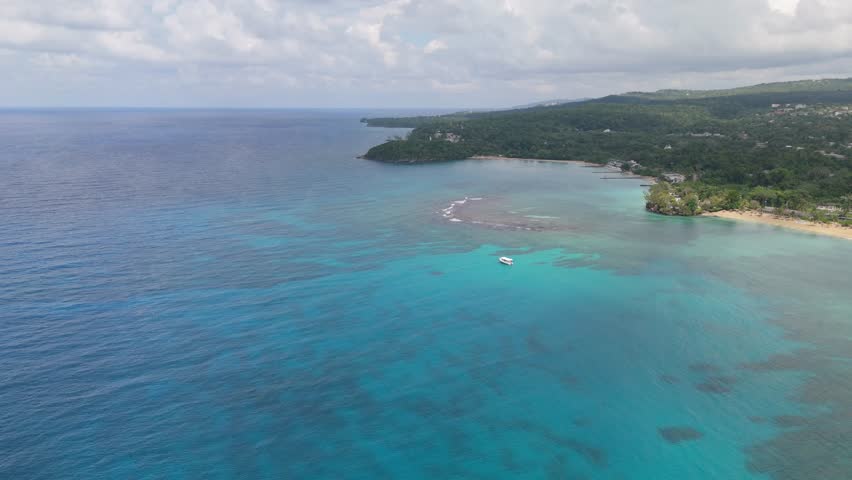 Blue Ocean In Jamaica With Plush Green Trees On The Island