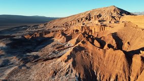 Sweeping 4K drone shot of glowing desert ridges and salt plains surrounding Valle de la Luna at golden hour. - Powered by Shutterstock - Get 15% off with code: PIKWIZARD15
