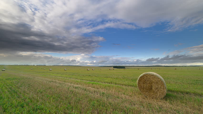 A Serene and Picturesque Countryside Landscape Featuring a Hay Bale Under a Dramatic Sky