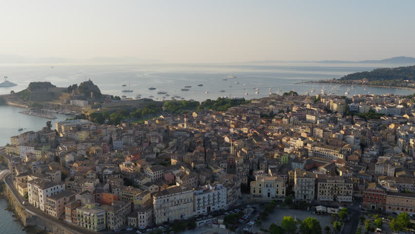 Old town of Corfu and yacht harbour with old fortress in view at sunrise, Drone shot, Panoramic view