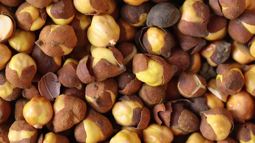 Roasted chickpeas close up macro video with peeled skins and detailed textured kernels in high resolution