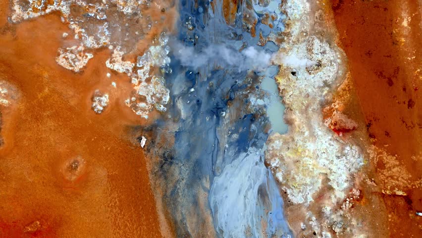 Drone footage of the sulfuric geothermal fields at Námafjall Hverir in northern Iceland. This alien-like landscape is filled with steaming vents, bubbling mud pots, and vivid yellow sulfur deposits