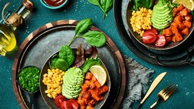 Healthy vegetable lunch with avocado, pumpkin, corn and lettuce. Vegetarian salad. Healthy balanced eating. Buddha bowl. - Powered by Shutterstock - Get 15% off with code: PIKWIZARD15