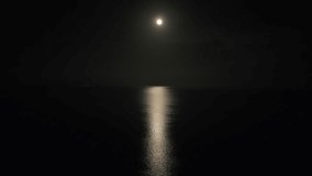 Crescent moon reflected in the calm relaxing sea in the night. Night scene. - Powered by Shutterstock - Get 15% off with code: PIKWIZARD15