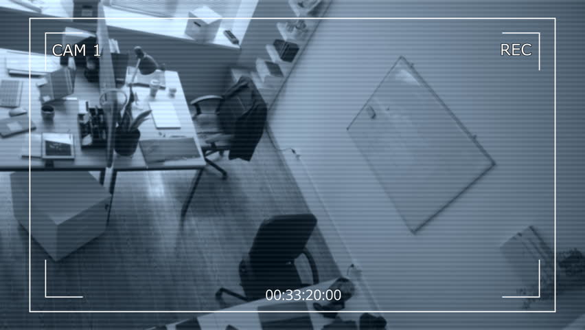 Security camera footage of two male criminals wearing masks hacking into corporate laptops while breaking into office during industrial espionage