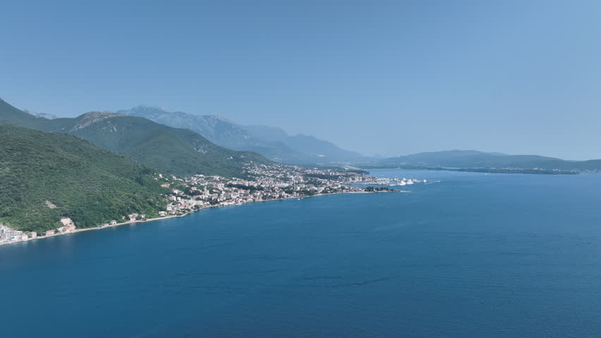 Scenic Aerial of Montenegro’s Coastal Town with Mountain Backdrop