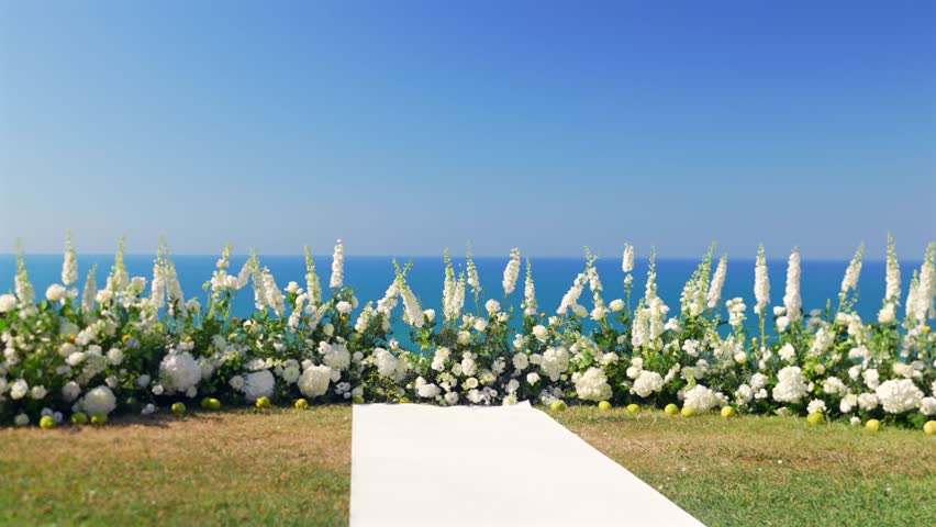 Close up of wedding floral arch with white flowers by the sea