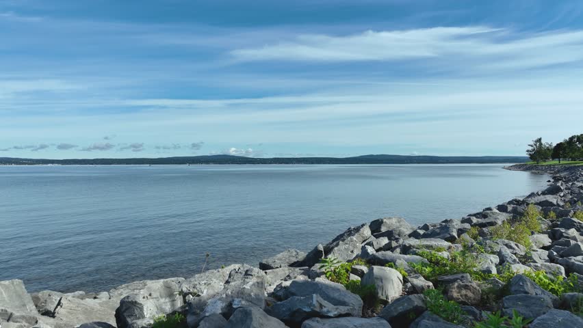 Slow parallax turn around the lakeshore of Lake Michigan in Petoskey, MI while rising in the air.