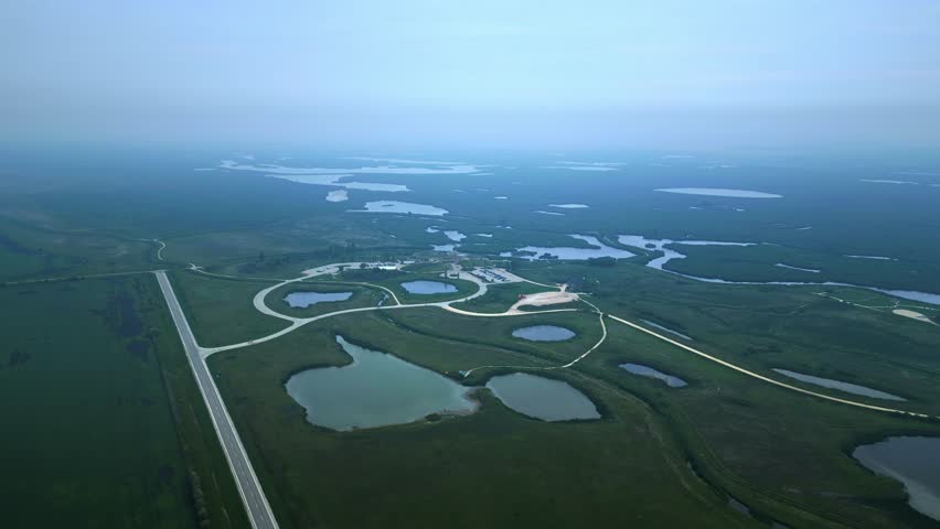 Aerial view of eco centre in northern Manitoba amid green wetlands and fog
