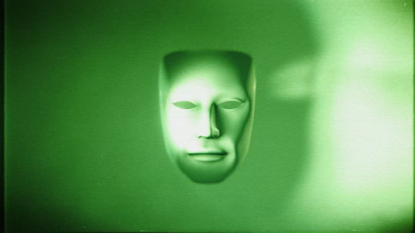 A spinning theatre mask with dramatic light and shadow in a stylised green night vision style with glitch TV noise.