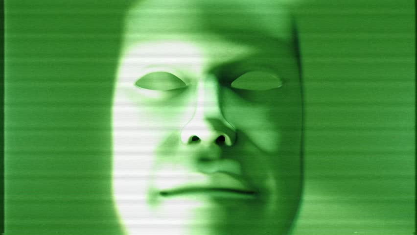 A strange shape morphing mask with dramatic light and shadow in a stylised green night vision style with glitch TV noise.