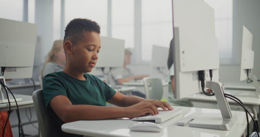 African American Smart Boy Using Computer, Doing Creative 3D Design Project. Teacher Helping Young Elementary School Student in Learning Coding During Digital Programming Lesson. Modern STEM Education