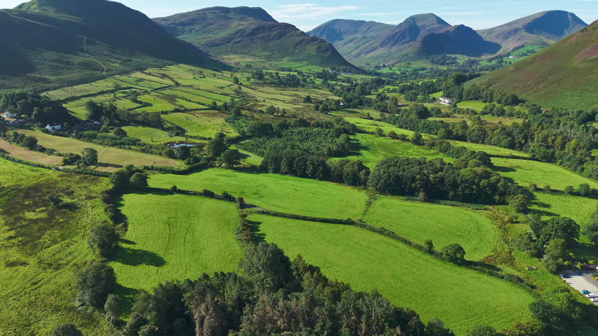 Idyllic rural landscape showing patchwork fields and fells in Cumbria, England.