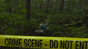 Yellow crime scene tape pulled around a forest area with a child bicycle or bike at cloudy day. - Powered by Shutterstock - Get 15% off with code: PIKWIZARD15