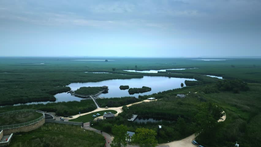 Slow Aerial Establishing Shot of Canadian Marshland with Lakes and Paths