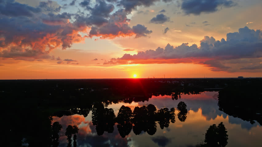 A Brilliant and Beautiful Orange Sunset Over The River In Tampa, Florida - Slow and Steady Aerial Shot