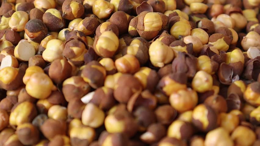 Roasted chickpeas close up macro video with peeled skins and detailed textured kernels in high resolution