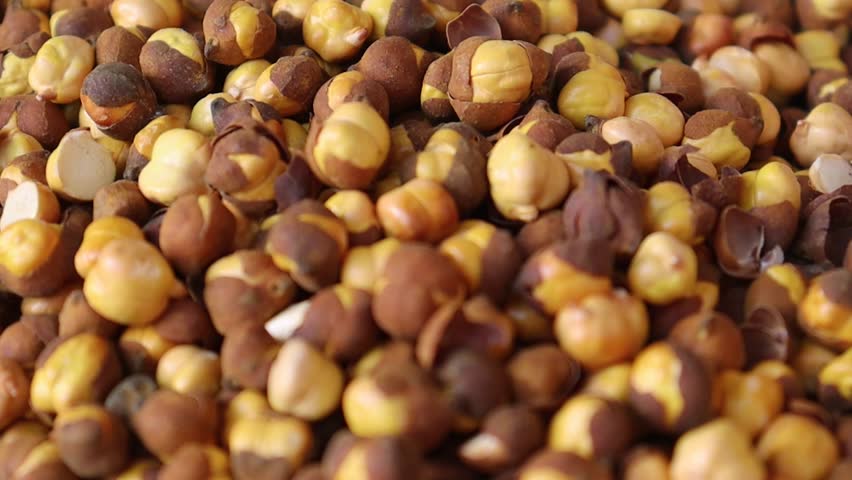 Roasted chickpeas close up macro video with peeled skins and detailed textured kernels in high resolution
