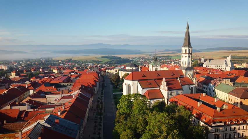 Majestic Levoča City Center at Dawn: Red Roofs, Towering Spires, and Misty Morning Glory