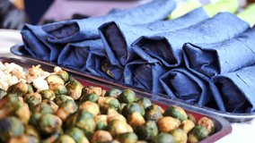 Indian street food vendor preparing traditional kati rolls and roasted brussels sprouts - Powered by Shutterstock - Get 15% off with code: PIKWIZARD15