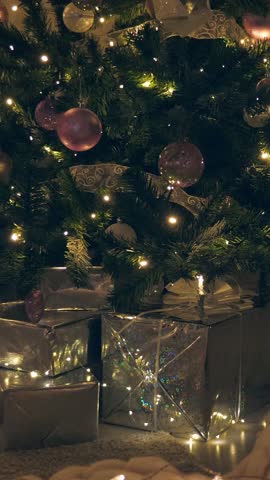 Christmas spruce tree decorated with balls and toys. New Year celebration. Closeup. Nobody. Vertical footage