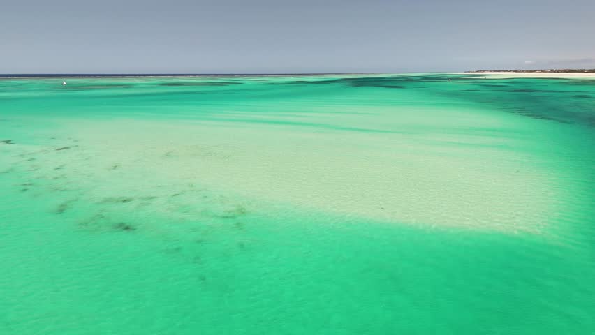 Shallow Sandbanks and Vibrant Aquamarine Tides Along Zanzibar's Shore, Tanzania