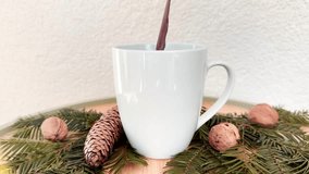 Pouring Cocoa Drink into White Mug — Hot Chocolate or Coffee on Evergreen Christmas Decor, Cozy Winter Scene - Powered by Shutterstock - Get 15% off with code: PIKWIZARD15